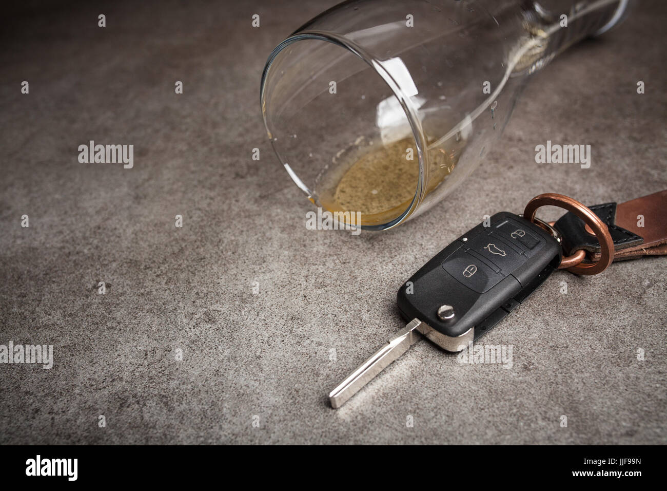 Drunk driving concept spilled beer and car keys on a table Stock