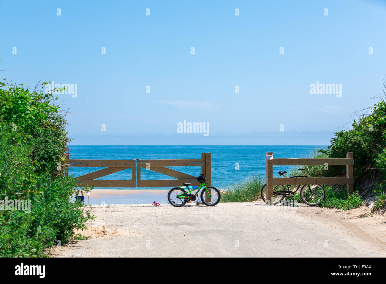 two bike resting against the gate at gibson beach, sagaponack ny Stock