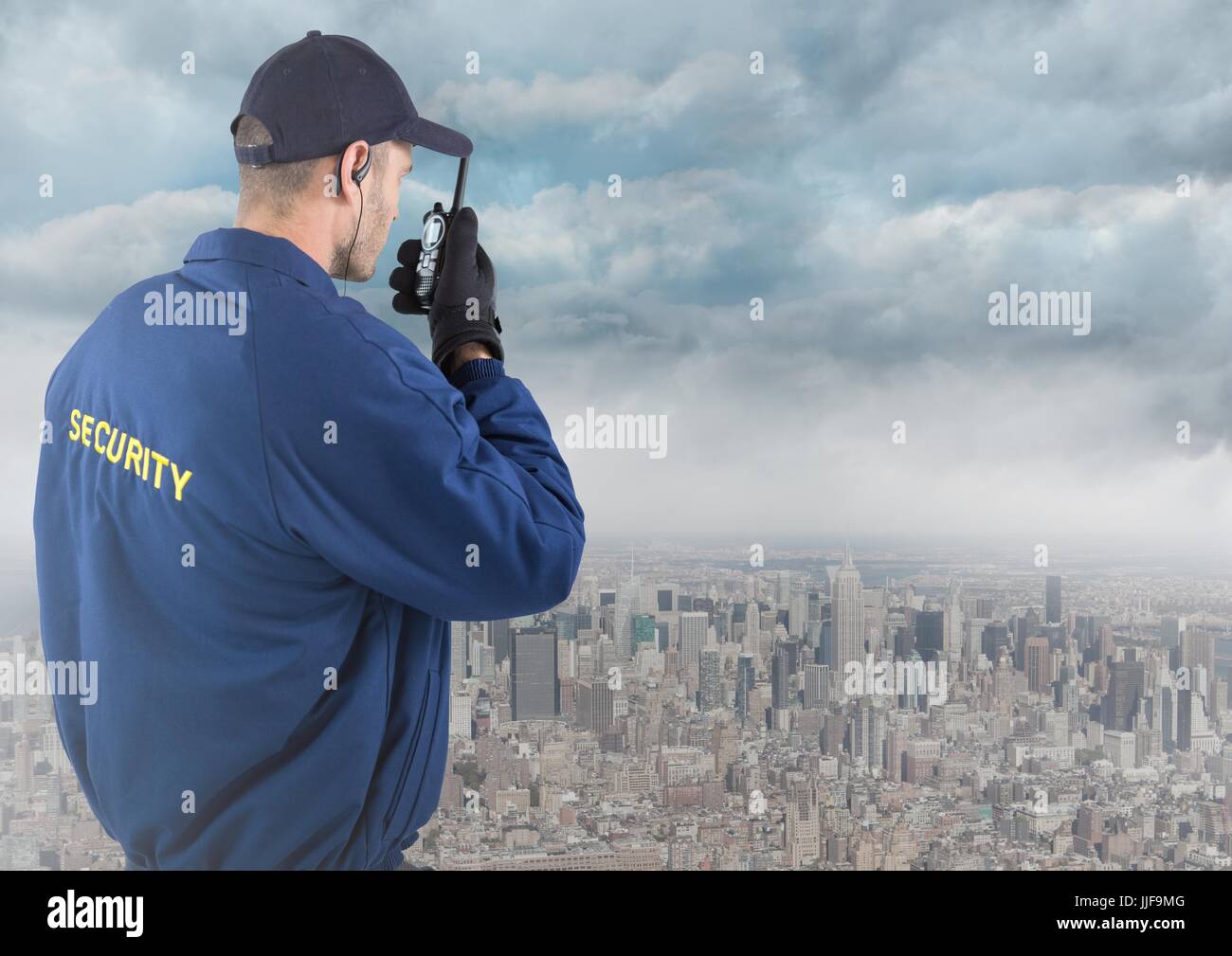 Digital composite of Back of security guard with walkie talkie against skyline and clouds Stock Photo