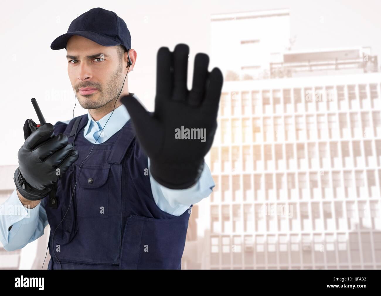 Digital composite of Security guard with walkie talkie and hand up ...