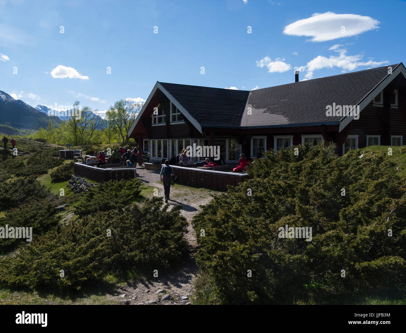 Visitors dining out in the sunshine at a cafe close to Engabreen glacier in Svartisen National Park Norway Stock Photo