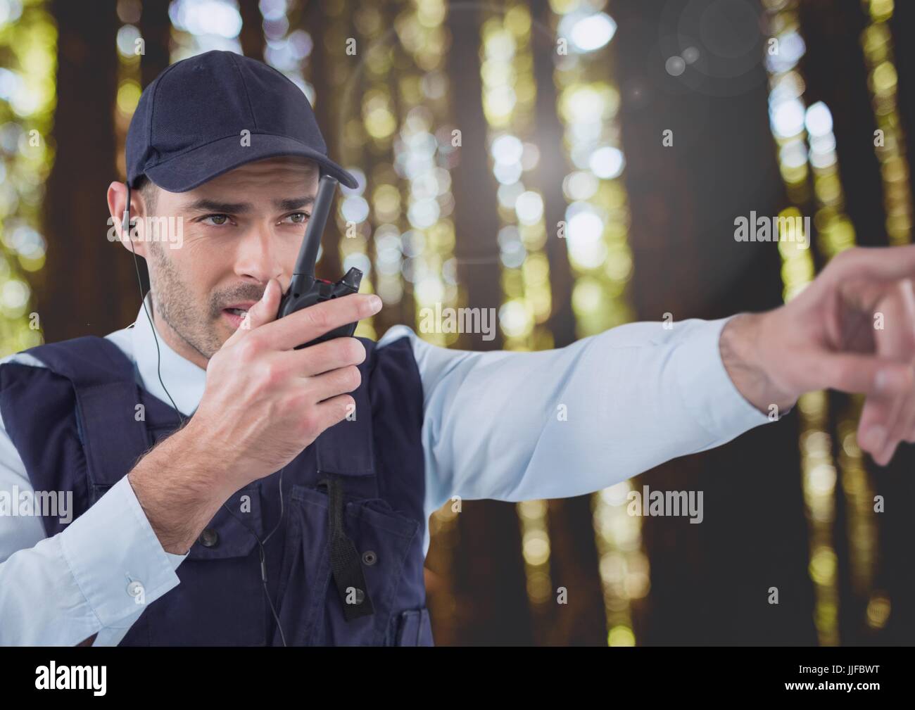 Digital composite of Security man outside in forest Stock Photo
