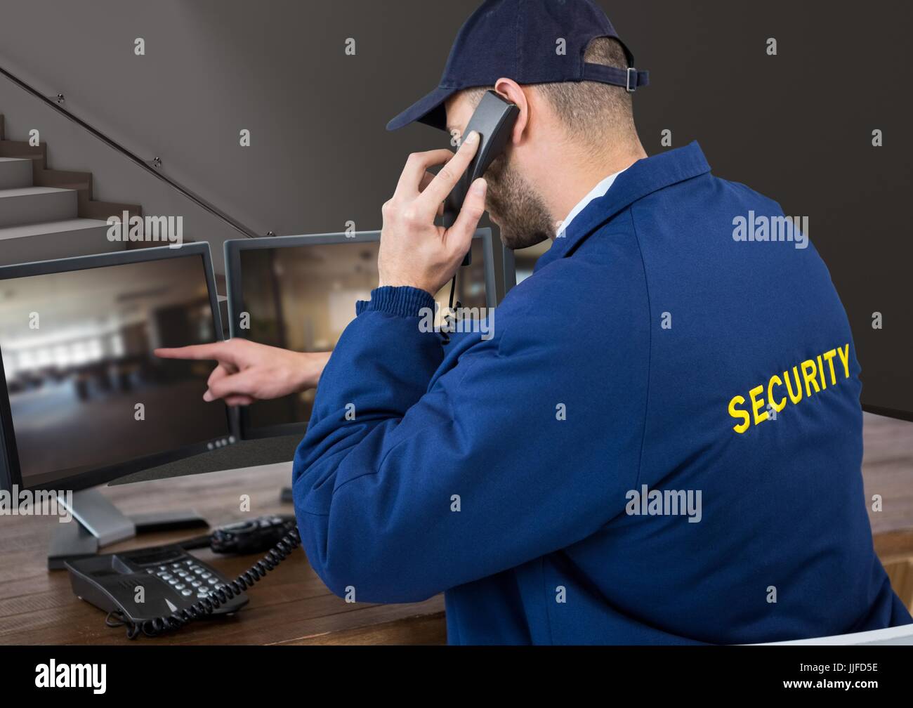Digital composite of security guard in his office phoning and pointing ...