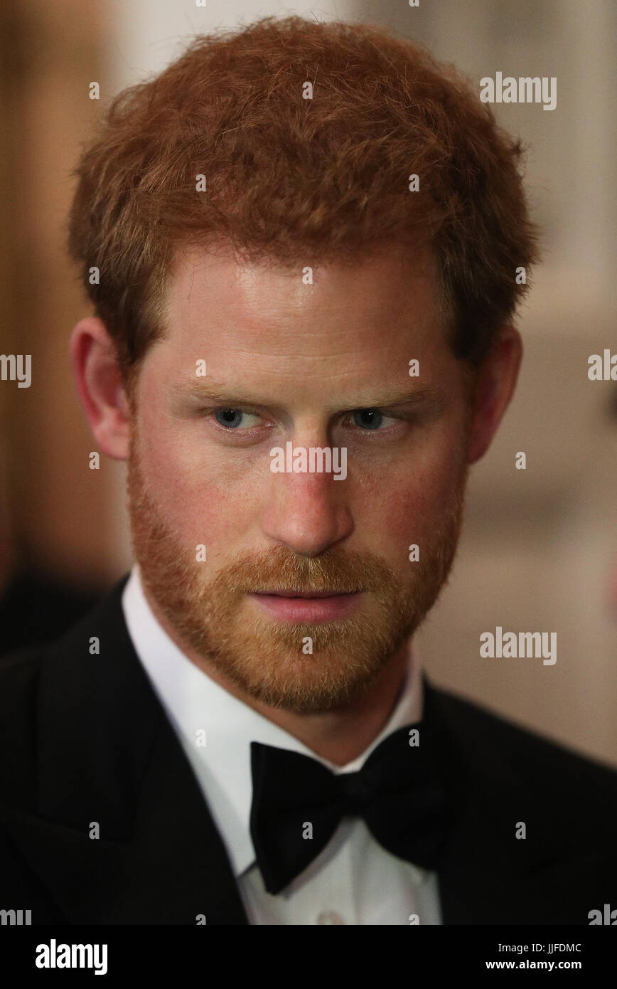 Prince Harry speaks to guests during a reception at Trinity House in