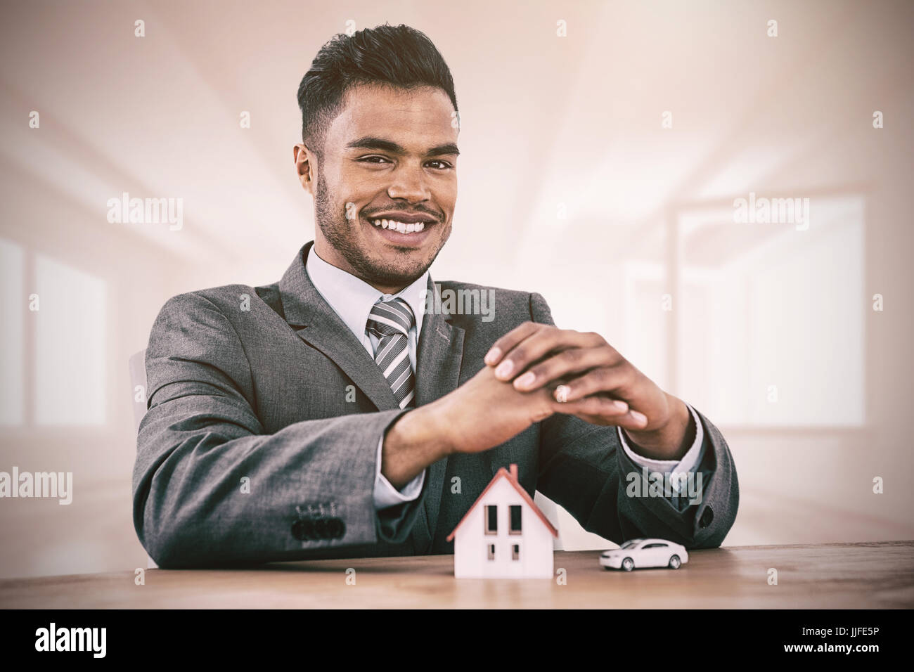 estate agent smiling against bright room with opened windows Stock