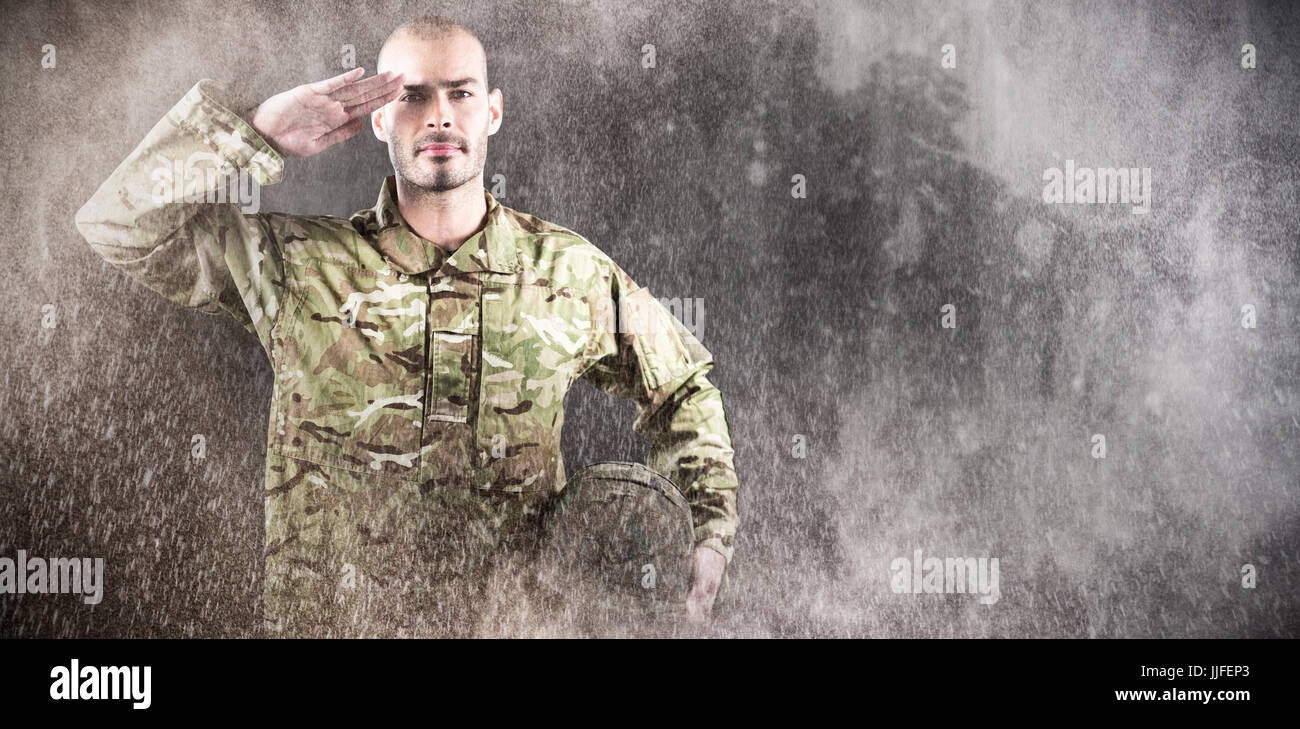 Portrait of confident soldier holding helmet while saluting against ...