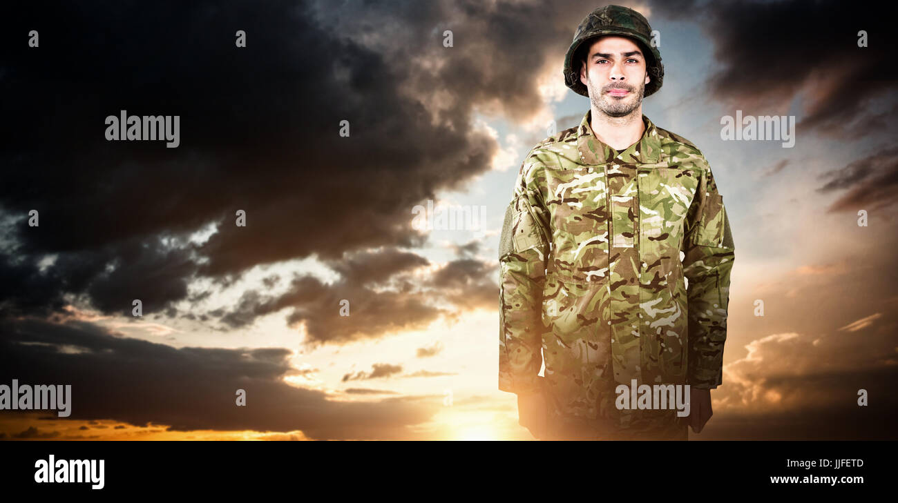 Portrait of confident military soldier standing against blue and orange ...