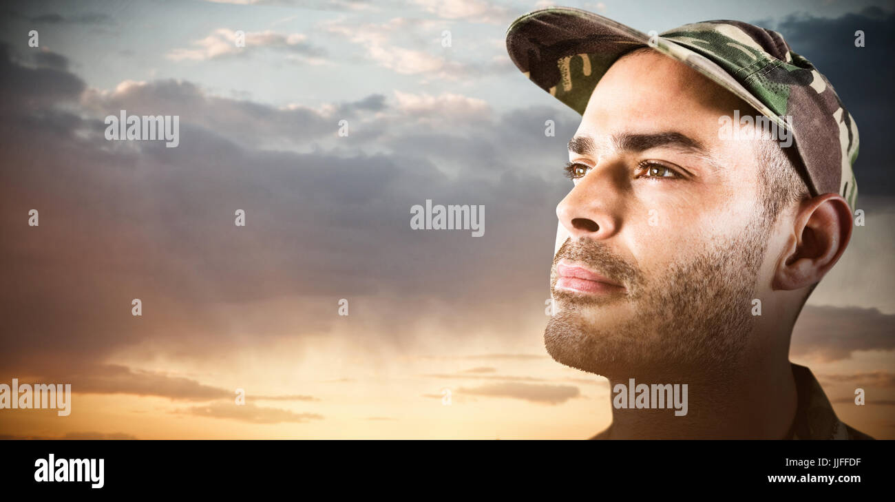 Close up confident soldier wearing cap against scenic view of cloudy ...
