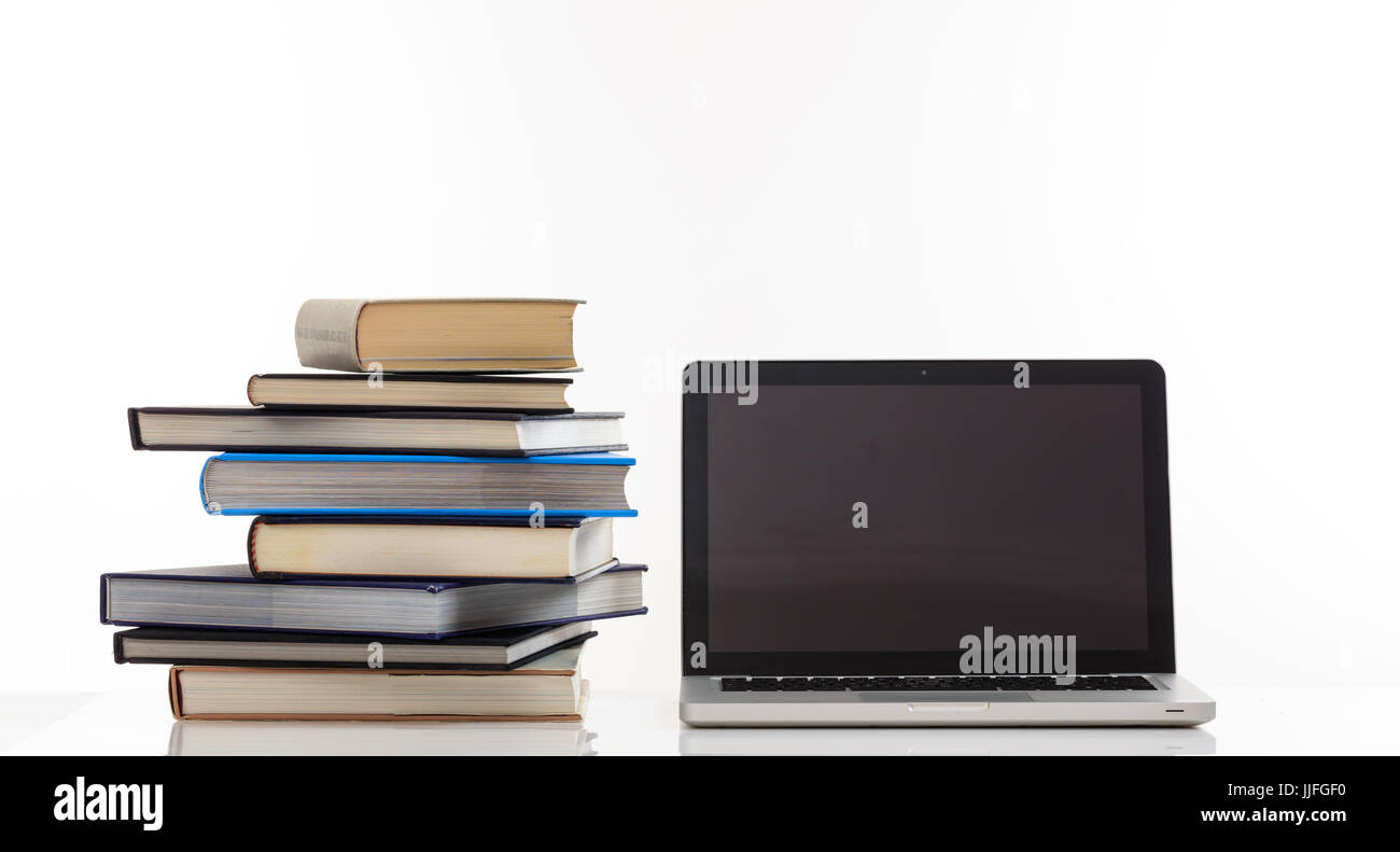 Education concept. Books stack and a laptop isolated on white ...