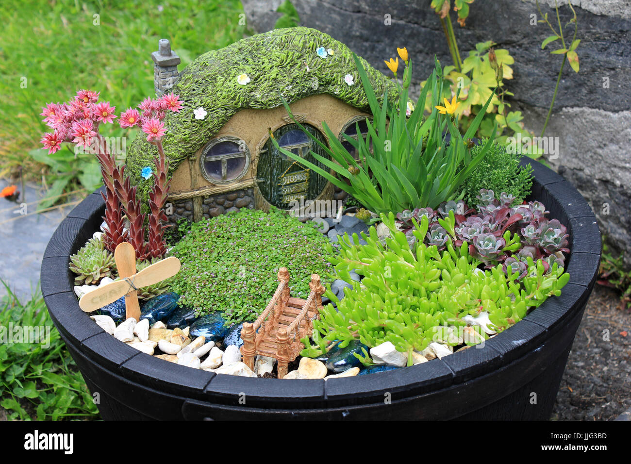 Amusing Fairytale Rockery Garden in Patio Tub Stock Photo