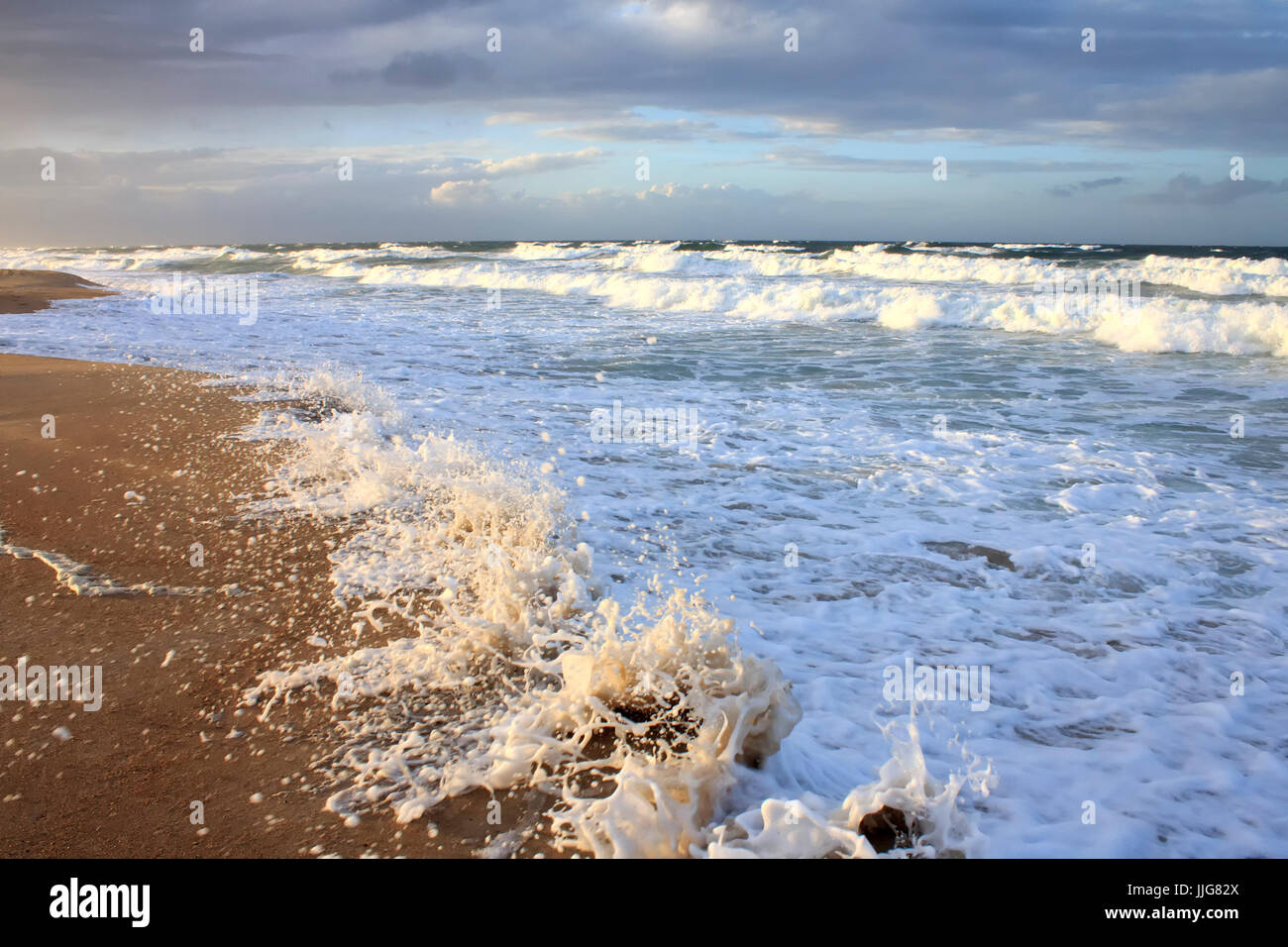 Waves crashing on beach showing beach erosion Stock Photo - Alamy