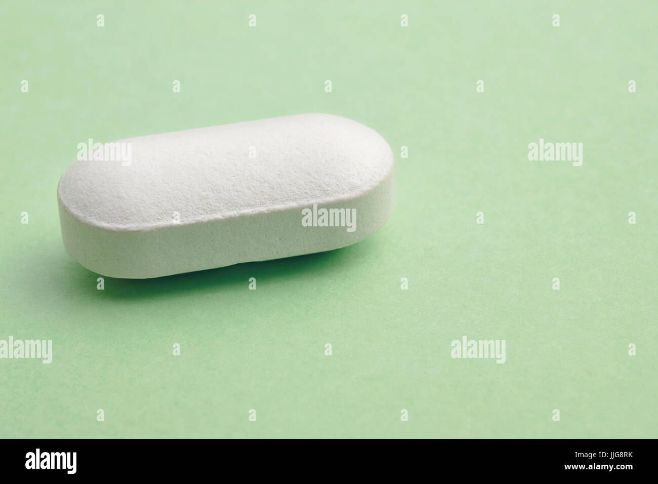 Pill over a green background. Medicament treatment. Health care photo