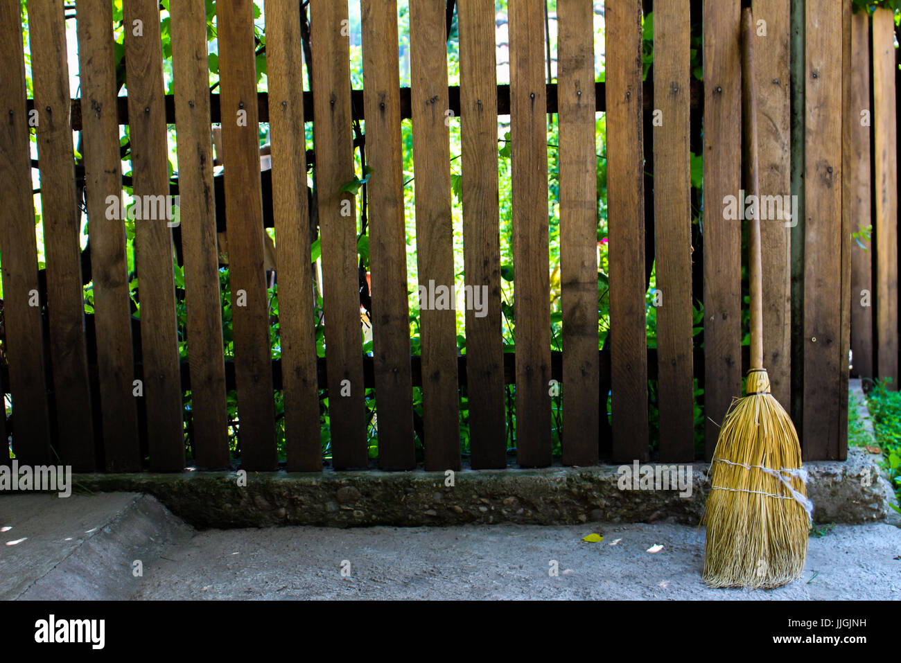 Rural wooden fence and a straw broom Stock Photo - Alamy