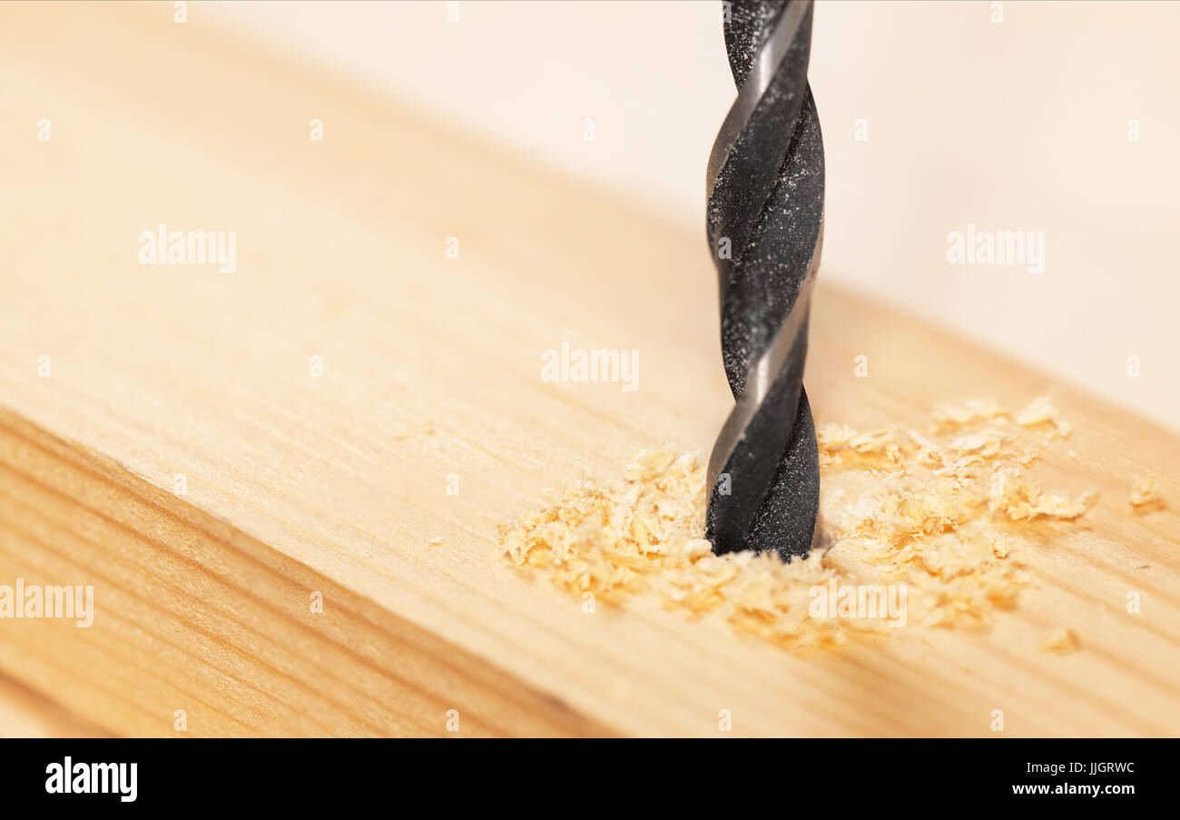 Metal drill bit make holes in a wooden plank Stock Photo Alamy