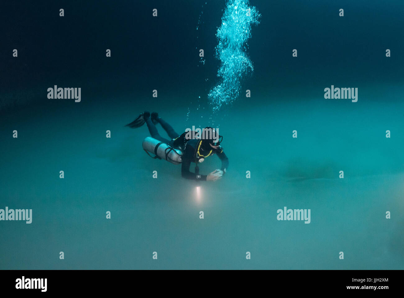 A scuba diver hovers above the strange hydrogen sulfide layer in Mexico's famed Angelita cenote. Stock Photo