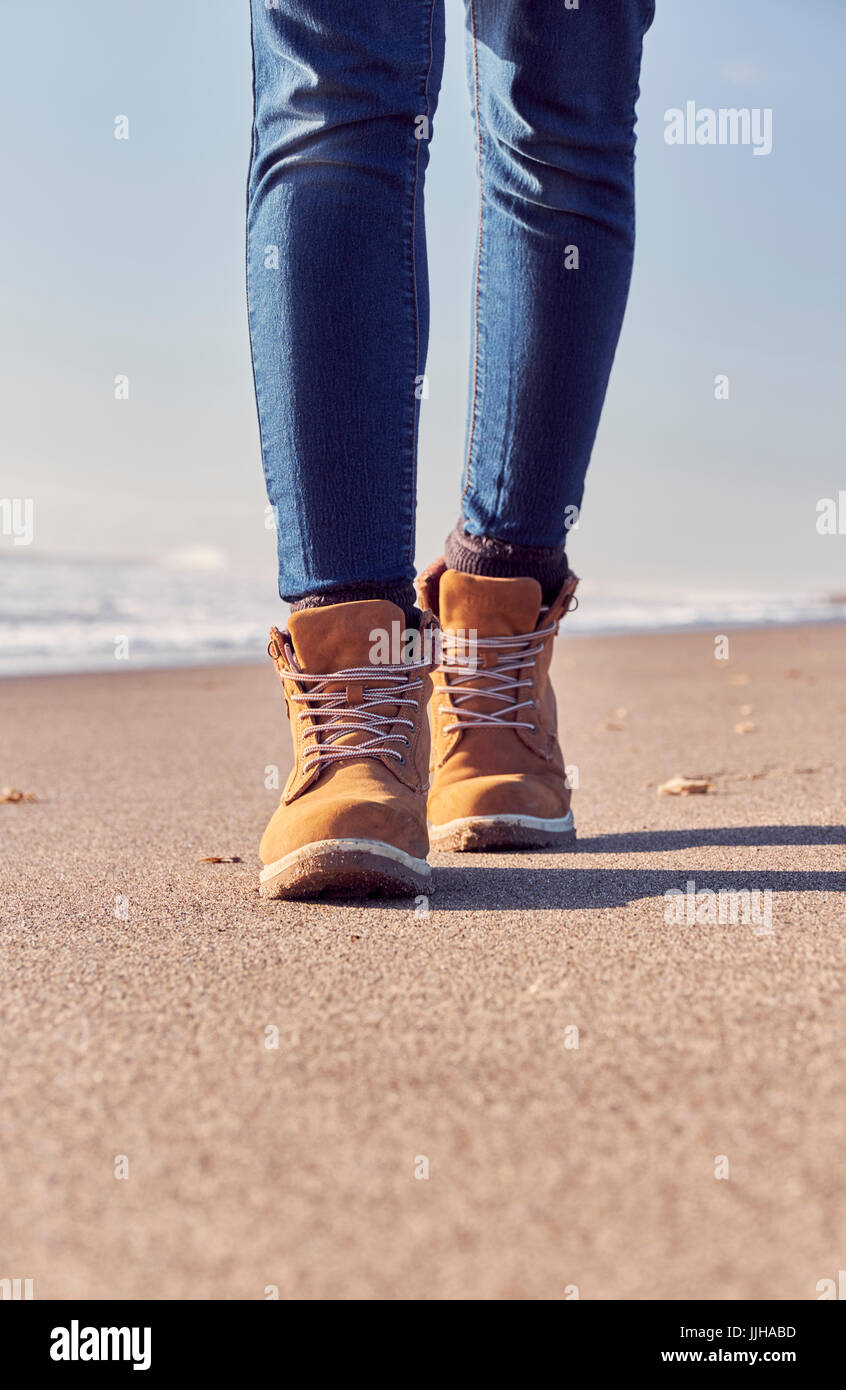 A young woman walking on the beach. Stock Photo