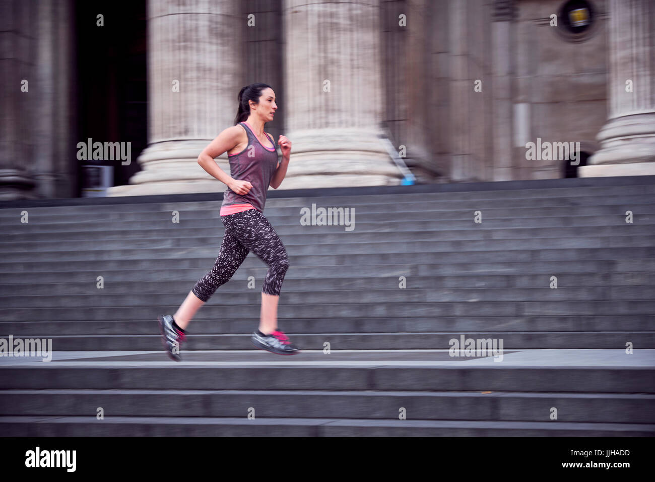 A woman running in the St Paul's area of London. Stock Photo