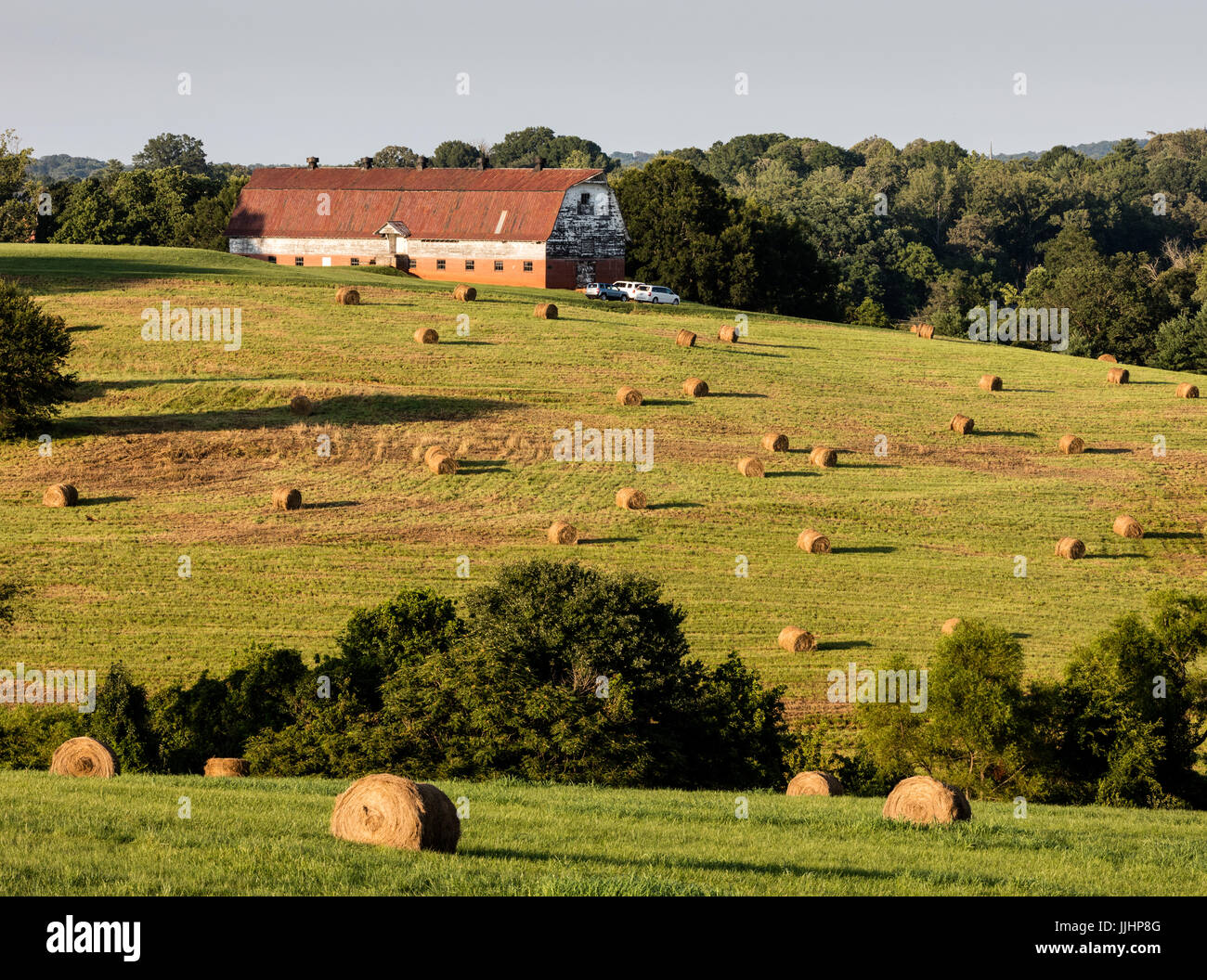 Sunset View of Farm & Barn with Hay Rolls in the North Carolina
