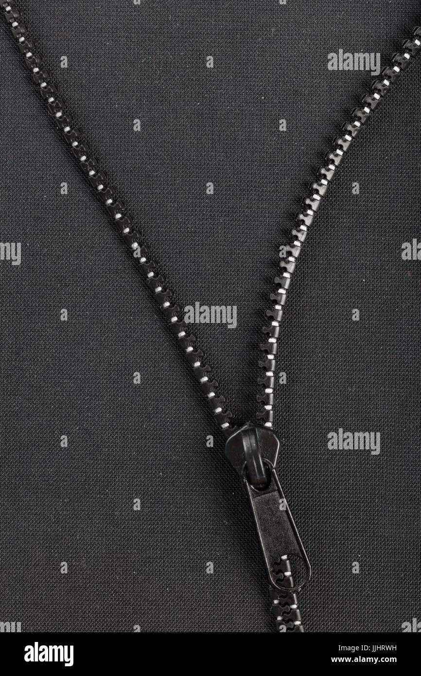 black plastic zipper with black  background and copy space. Stock Photo