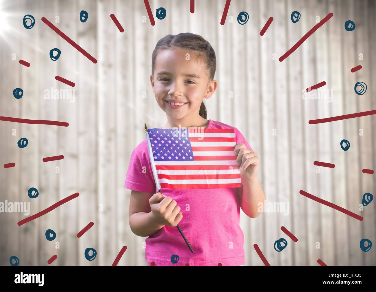 Girl holding american flag against blurry wood panel with firework doodle Stock Photo