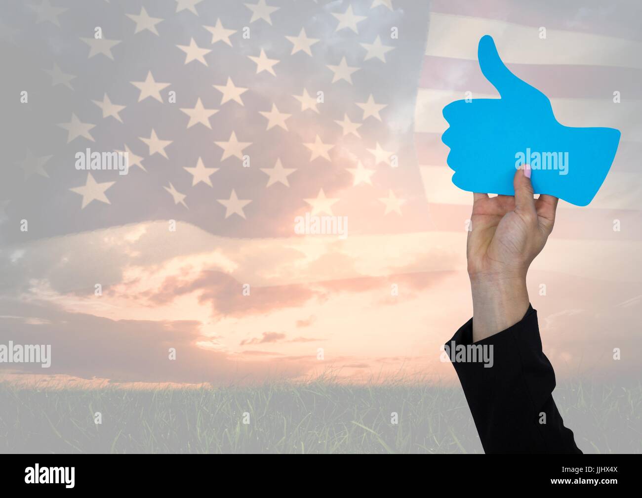 Business man hand holding a thumb up against american flag Stock Photo