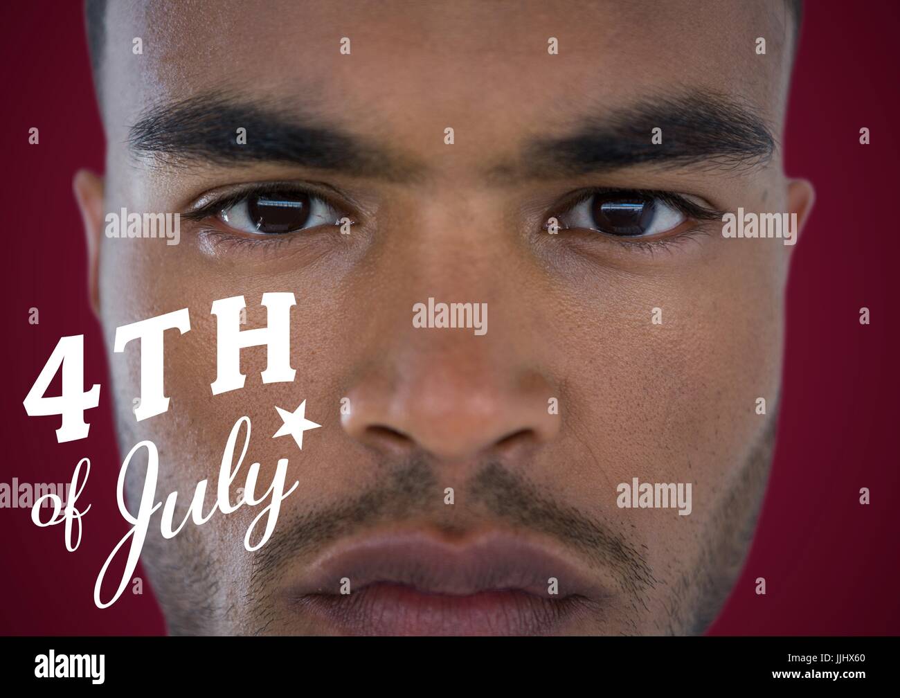 Portraiture of man with white fourth of July graphic against maroon background Stock Photo
