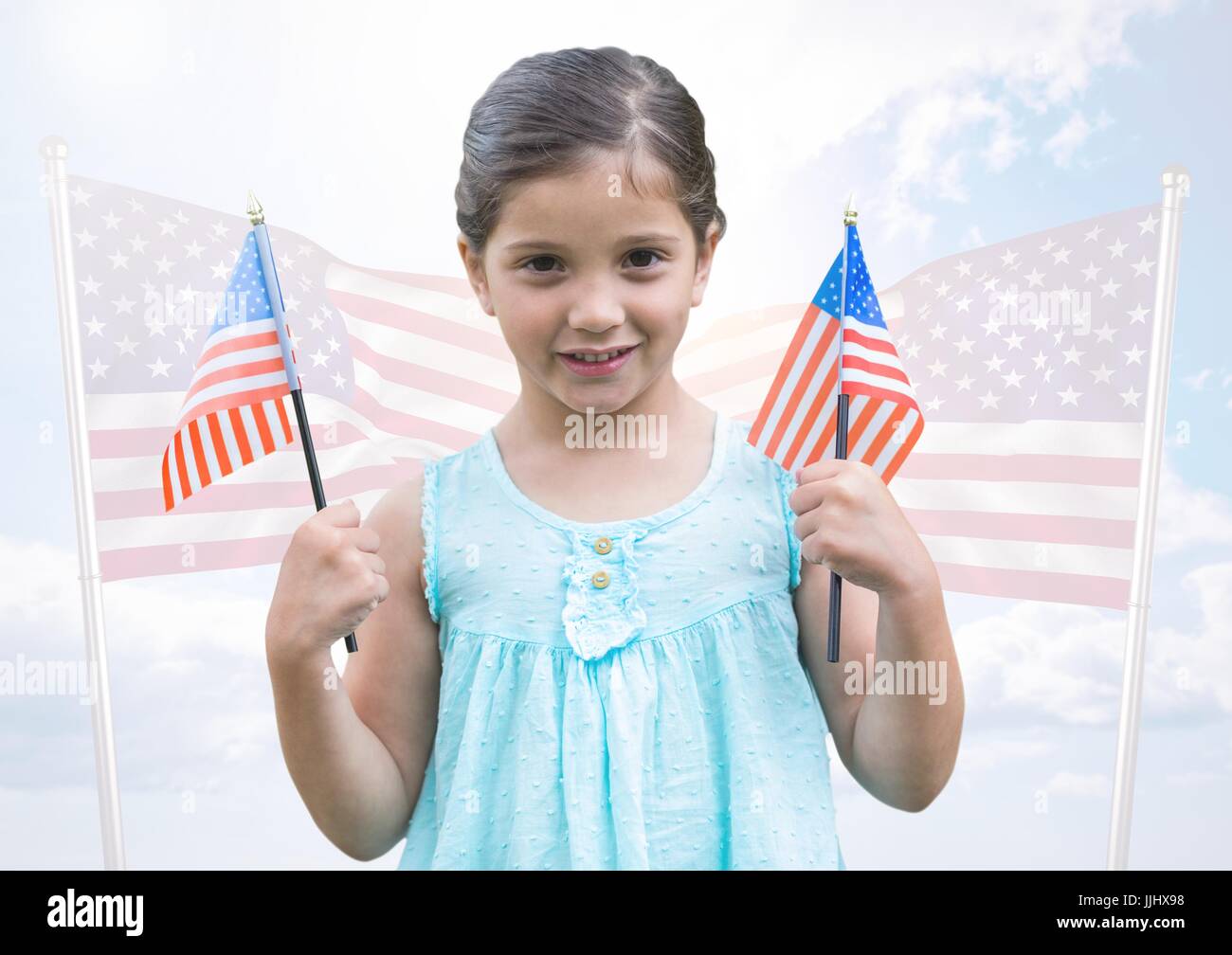 Girl holding american flags against fluttering american flags Stock Photo