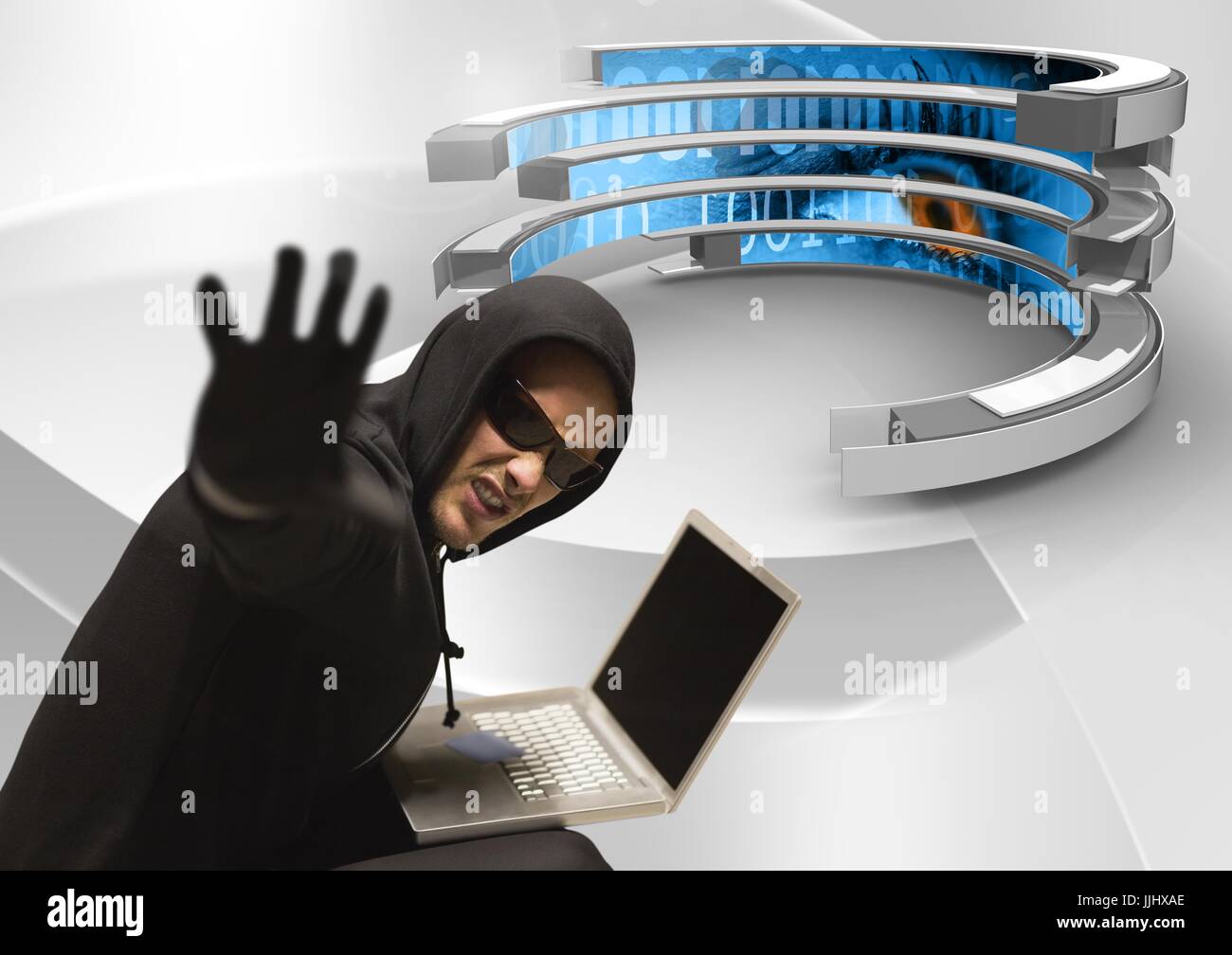 Hacker tendering his hand and using a laptop in a 3d data center Stock Photo