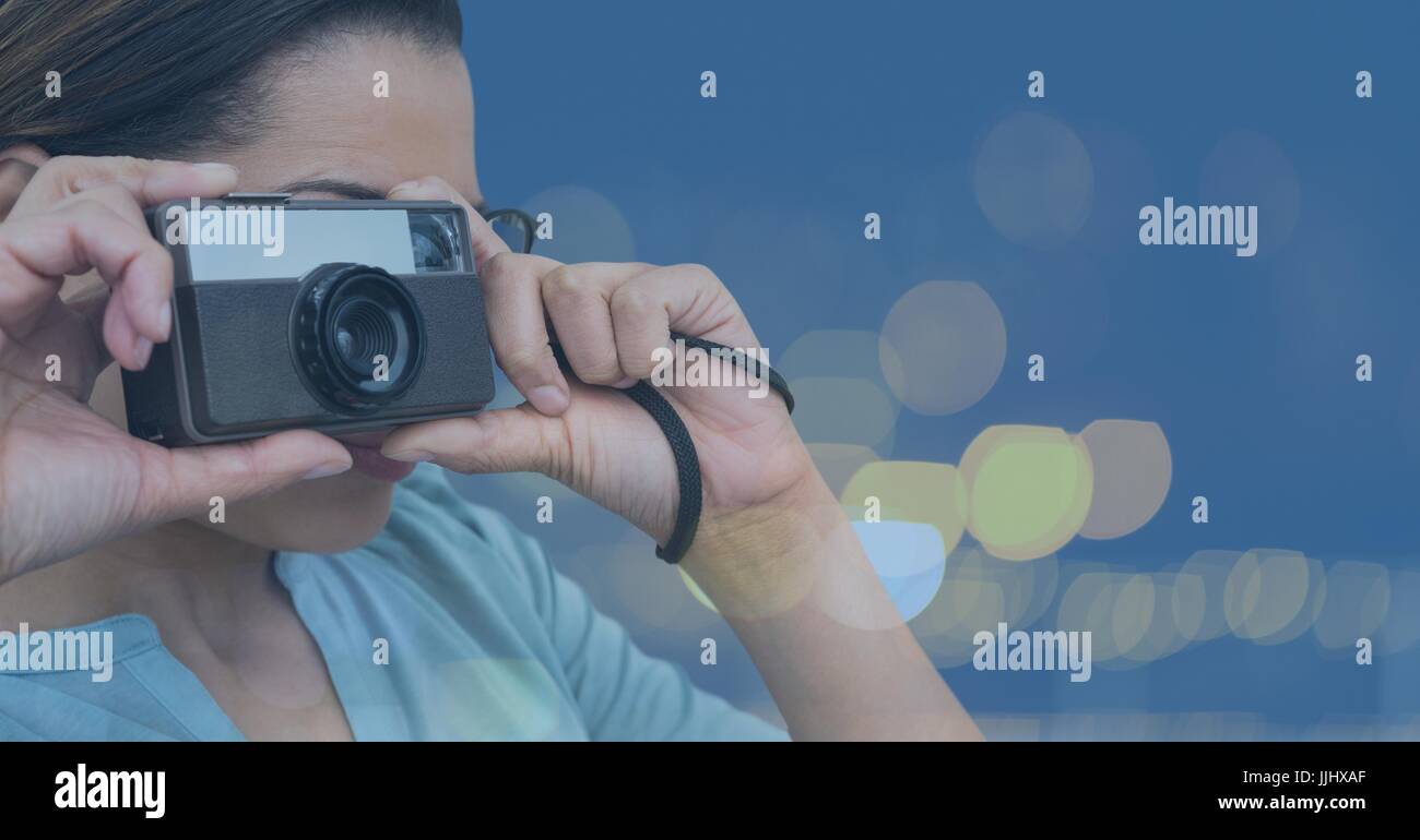 Photographer taking picture in colored lights background Stock Photo