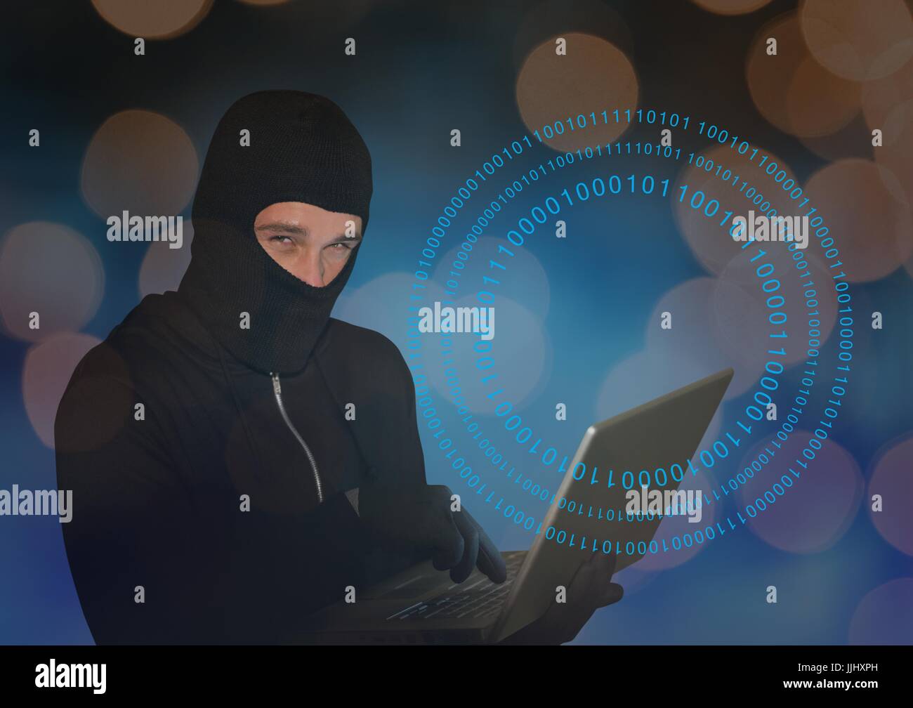 Hacker in black hood laptop hi-res stock photography and images - Alamy