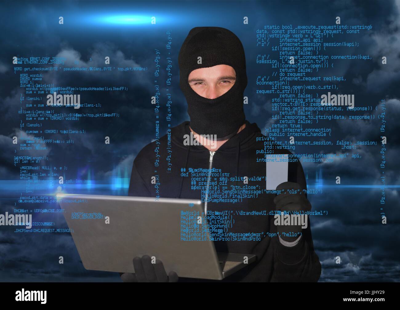 Hacker working on laptop in front of blue digital background Stock ...