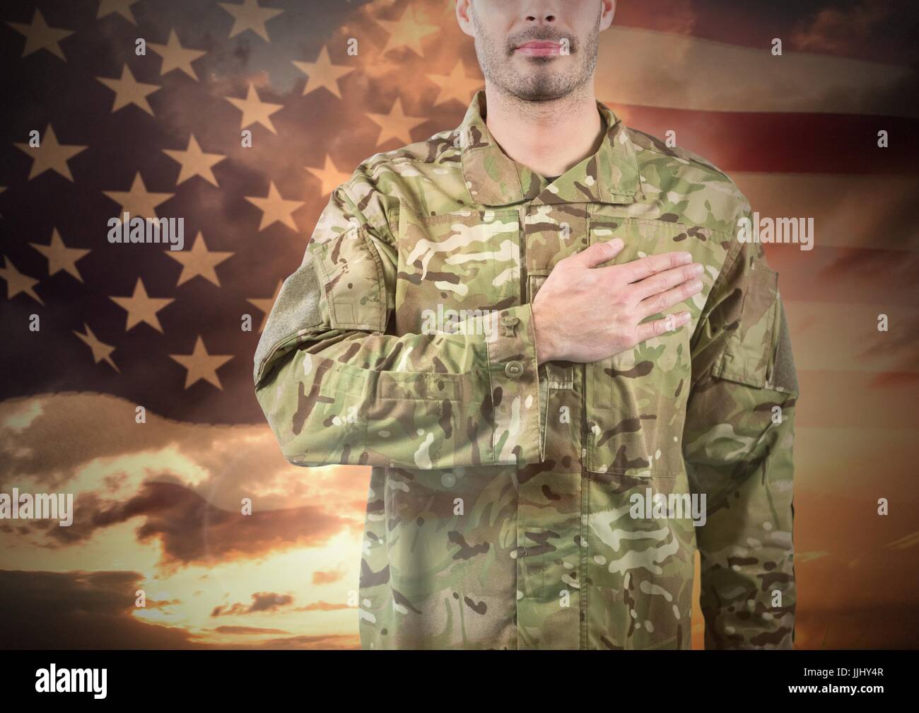 Military with hand on his heart against sunset and american flag Stock ...
