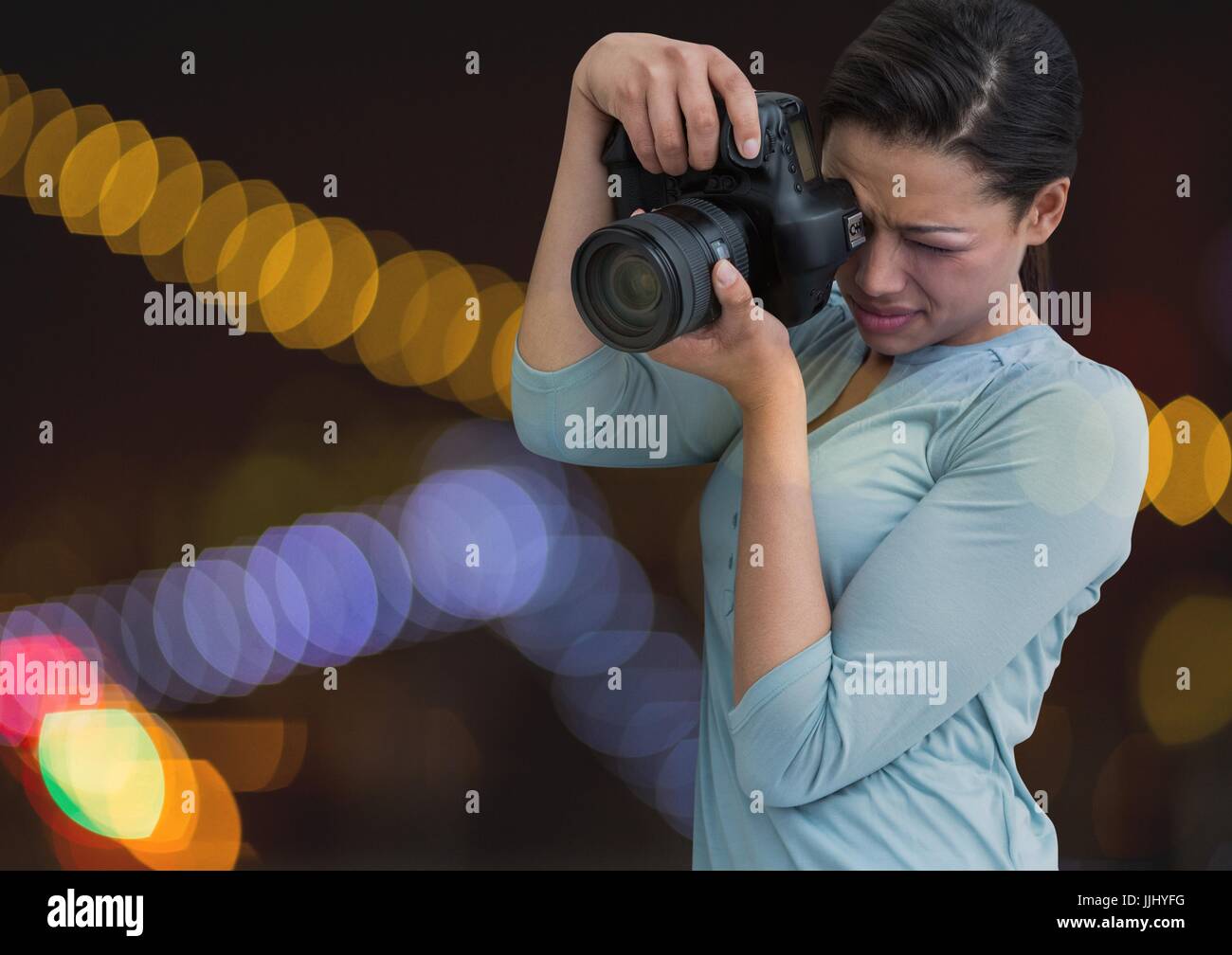 Photographer taking picture in colored lights background Stock Photo