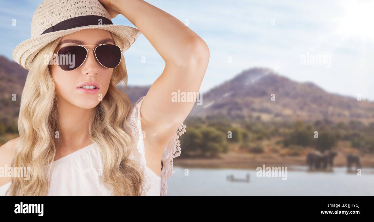 Close up of woman in summer clothes against African scene with flare Stock Photo