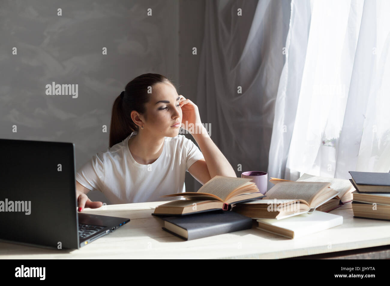 girl works at the computer reads books Stock Photo - Alamy