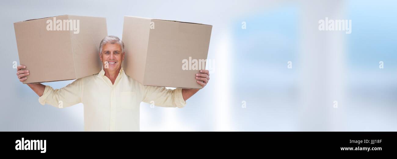 Man holding boxes in front of blurred background and copy space Stock Photo