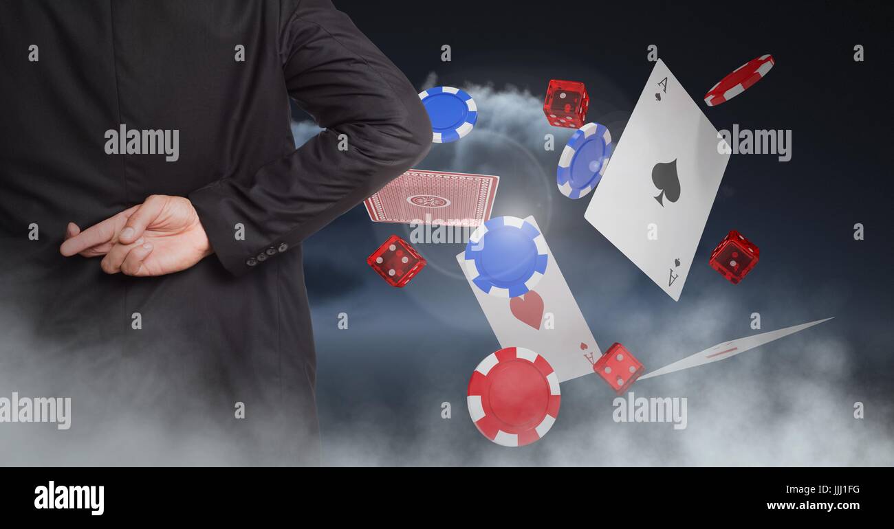 Fingers crossed behind back with poker chips and playing cards Stock