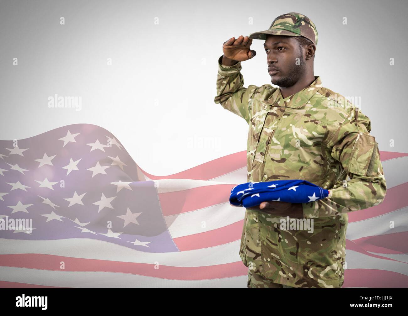 Black soldier holding an american flag for independence day against a ...