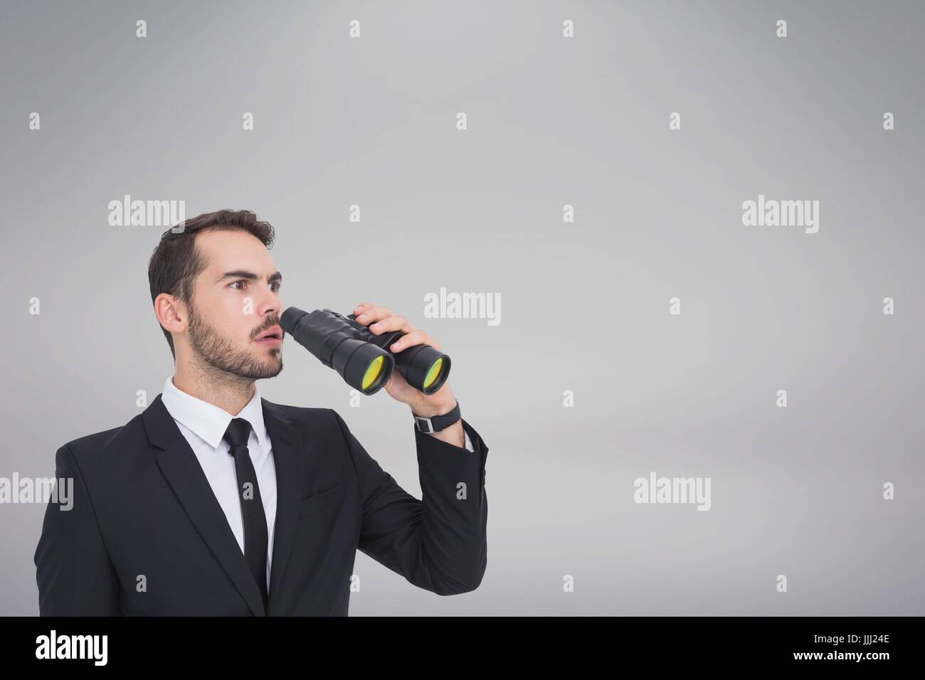 Confused man with binoculars against white copy space background Stock