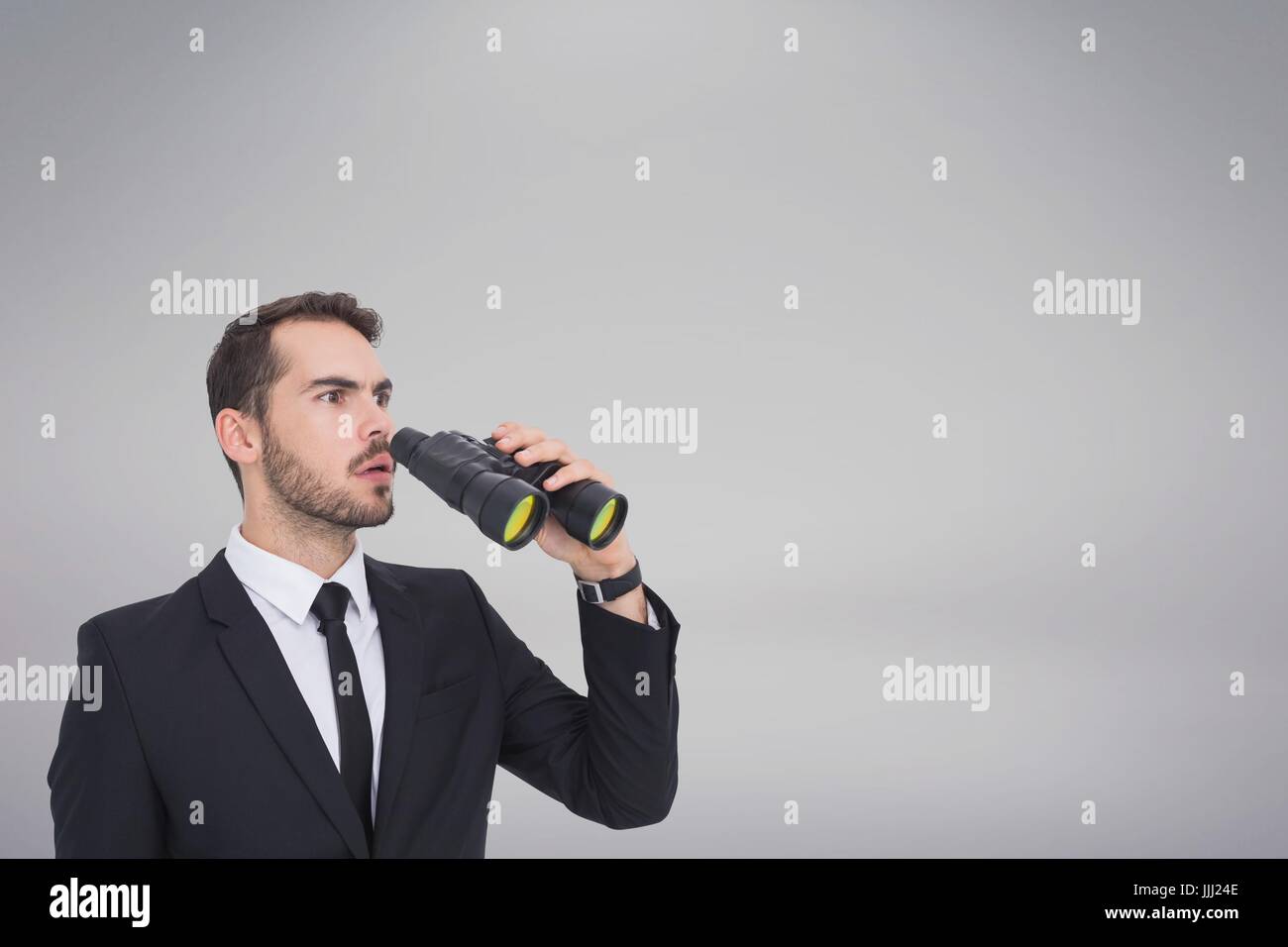 Confused man with binoculars against white copy space background Stock Photo