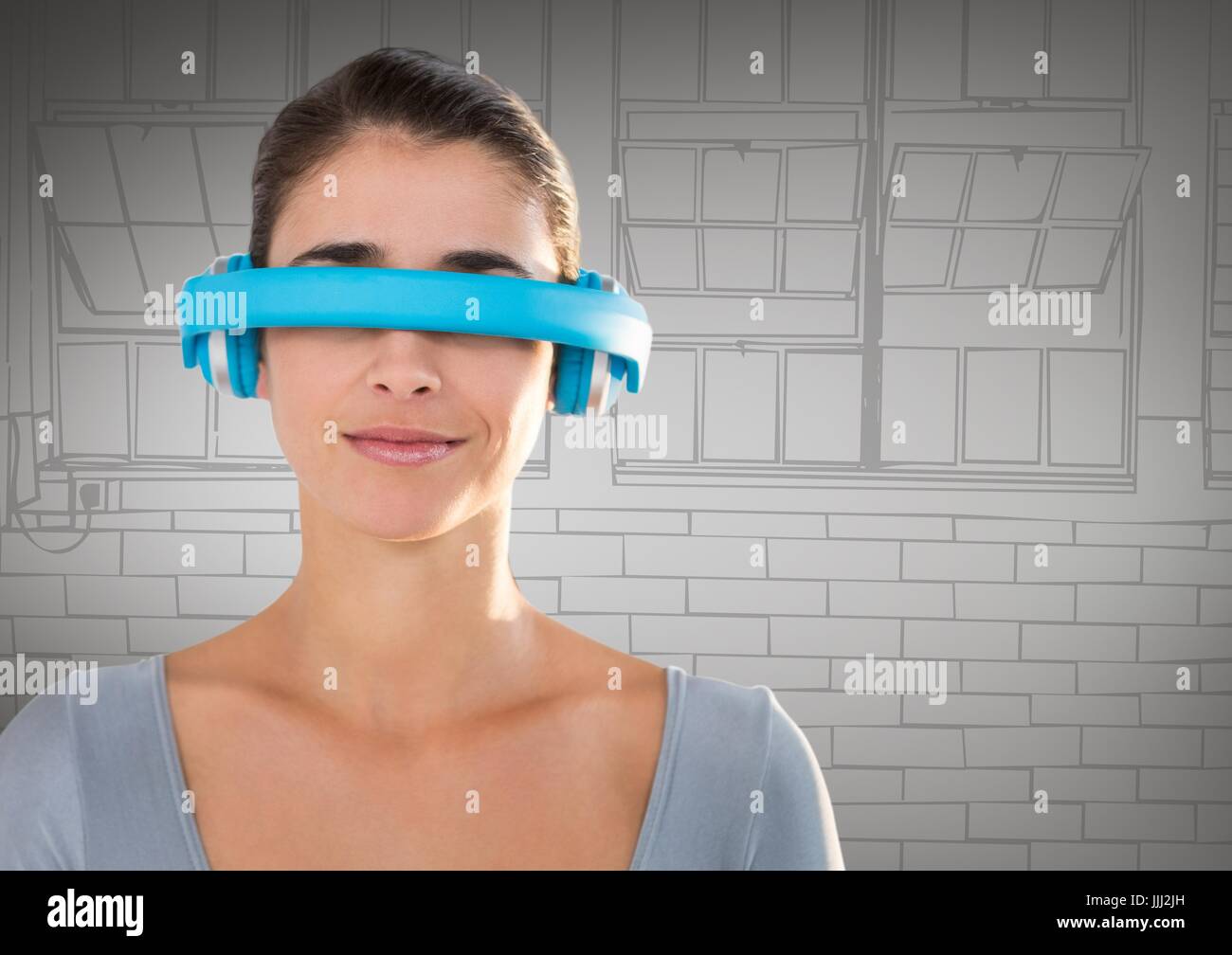 Woman in blue virtual reality headset against grey hand drawn windows Stock Photo