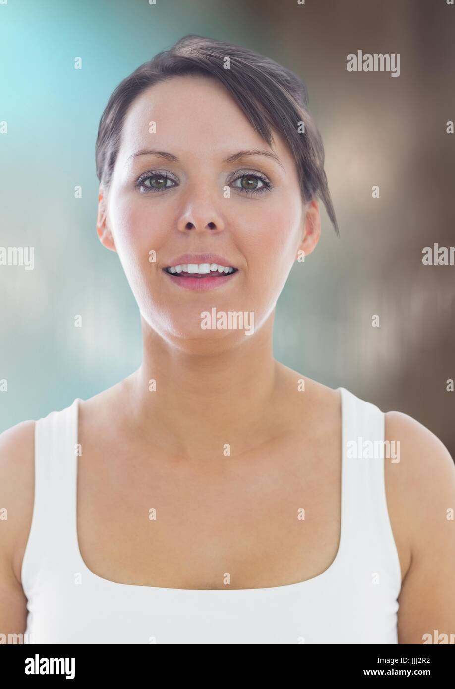 Woman in tank top against blurry blue brown background Stock Photo