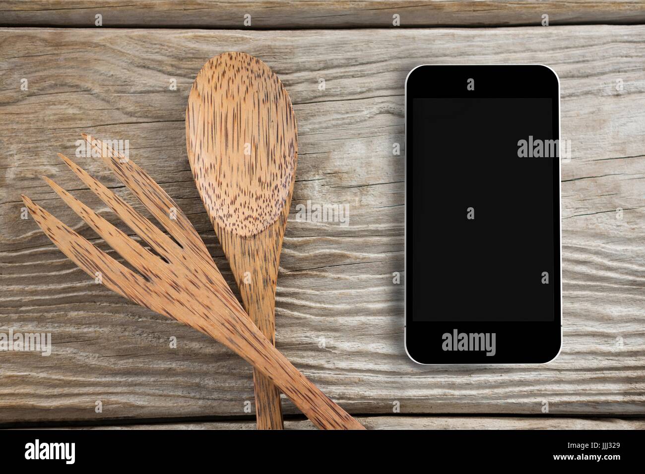 Phone on wooden desk and copy space on mobile phone Stock Photo