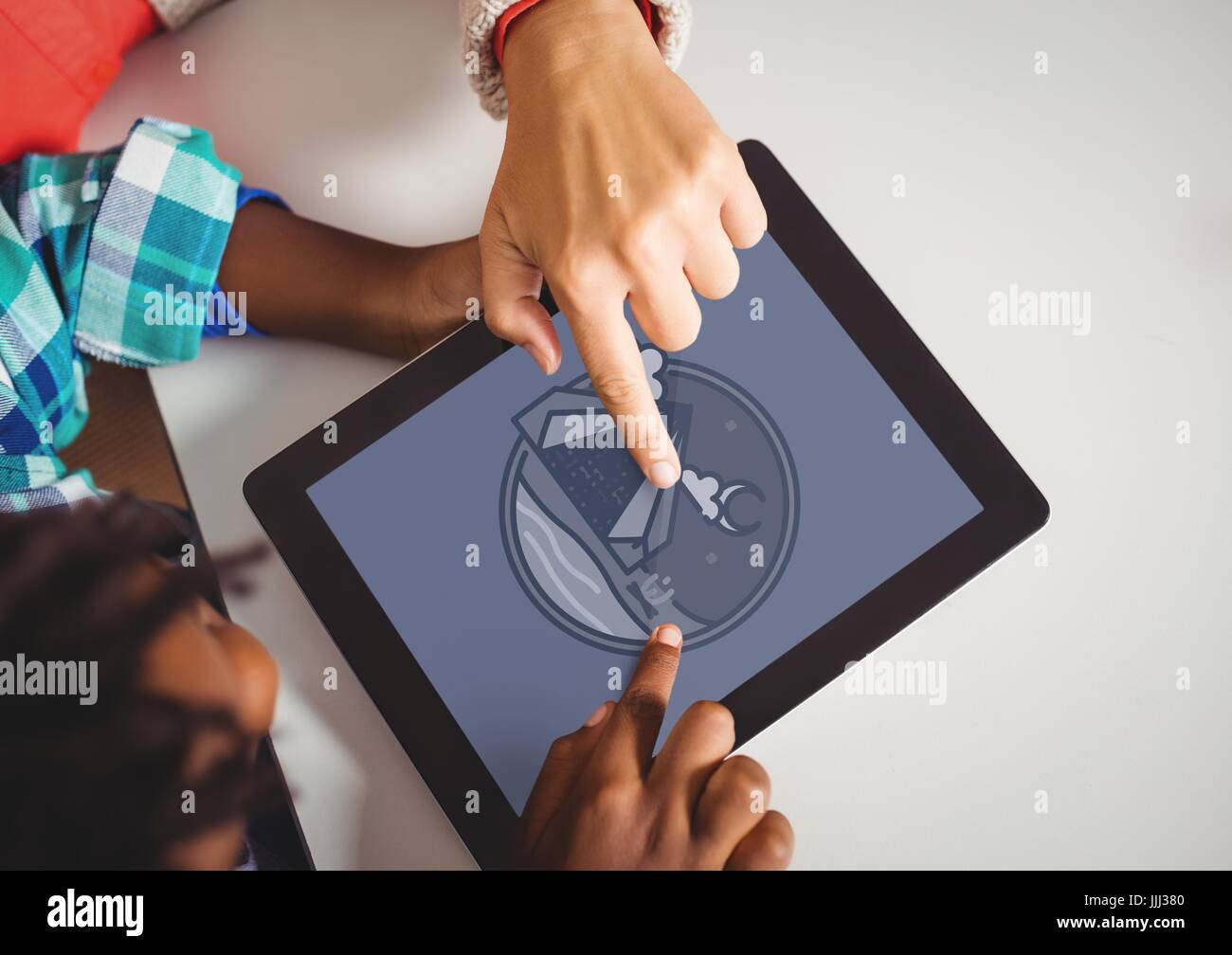 Boys holding a tablet with travel icon on the screen Stock Photo