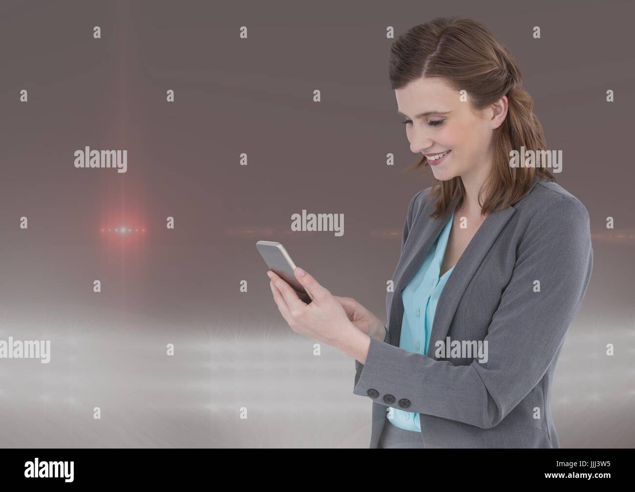 Smiling woman texting in colored fog Stock Photo Alamy