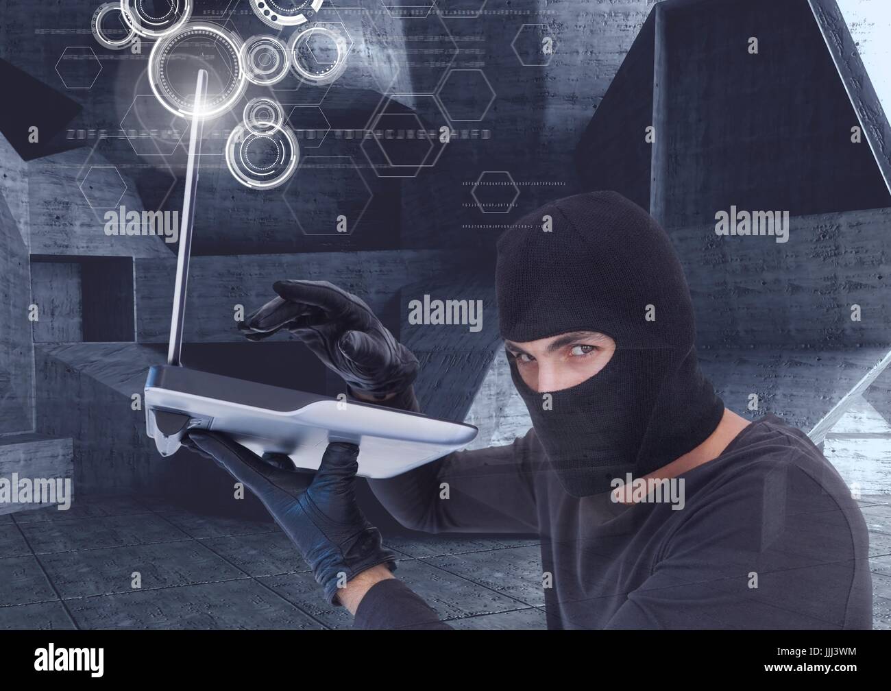hacker using a laptop in a minimalist room Stock Photo