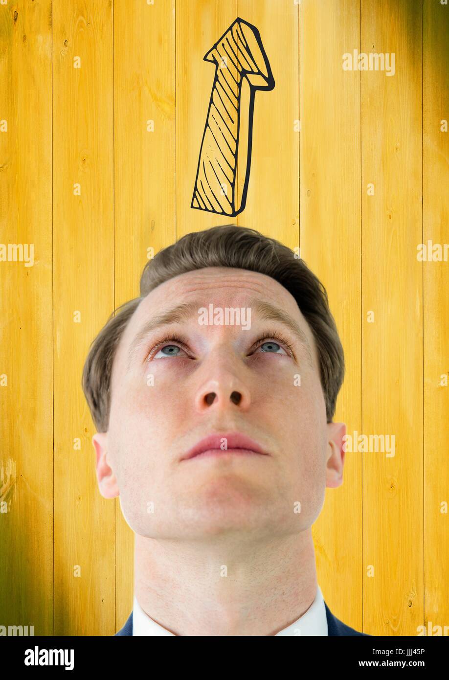 Man looking up at grey upward 3D arrow against yellow wood panel Stock Photo