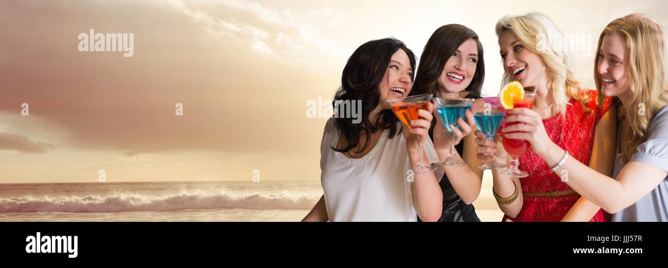 Women with cocktails on sunset beach and copy space Stock Photo