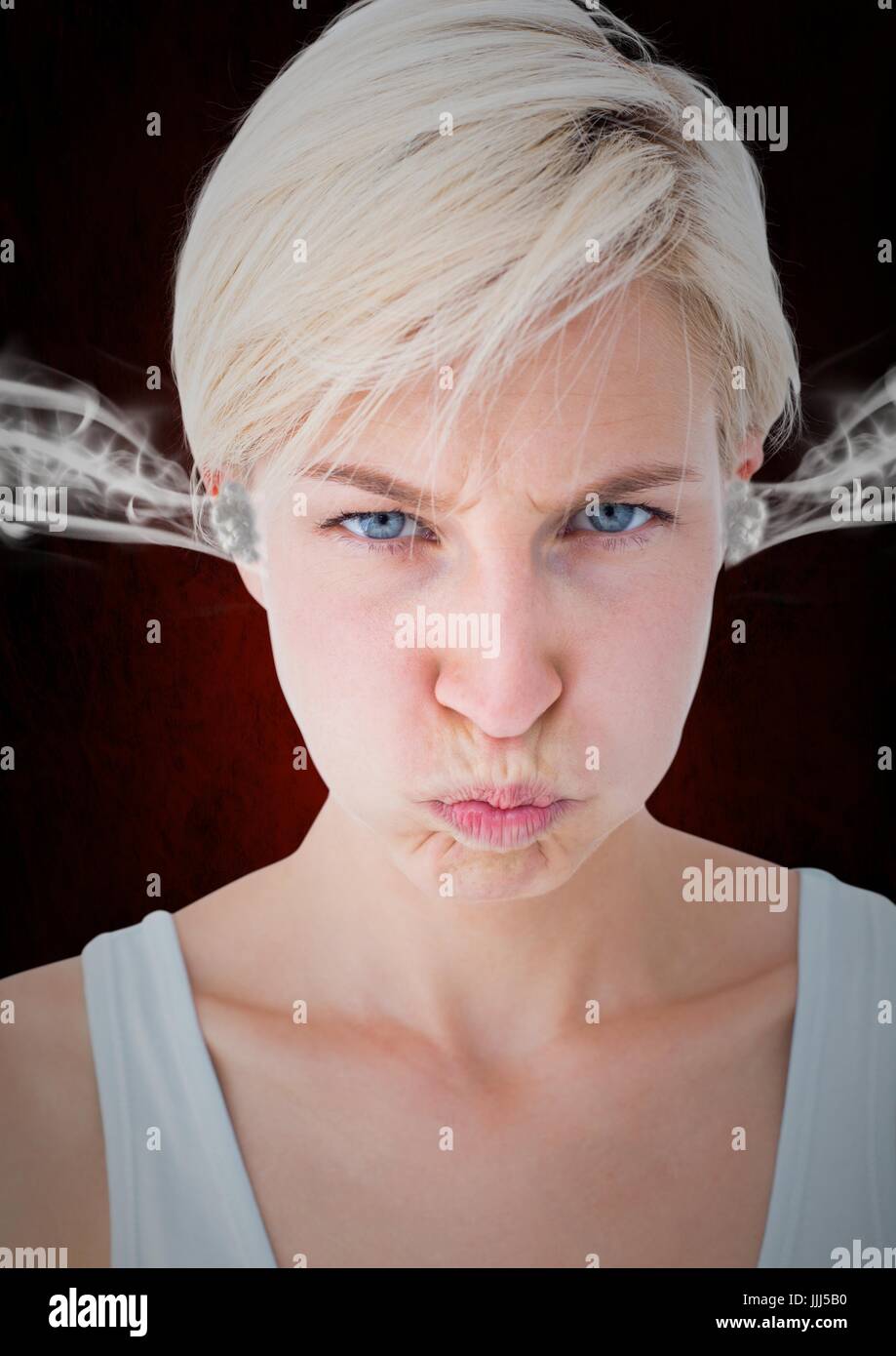 anger young woman with 3D steam on ears. Black and red background Stock Photo