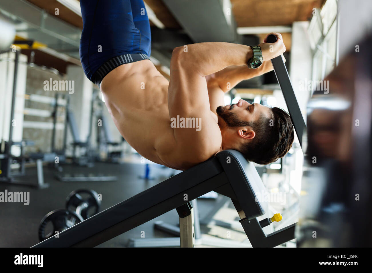 Young handsome man doing exercise for abdominal muscles Stock Photo